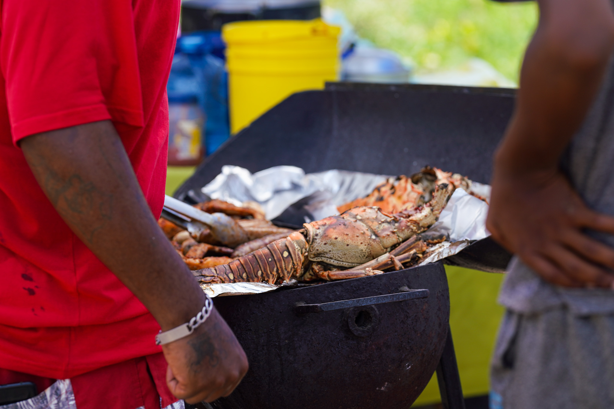 locals in Belize preparing grilled lobster at Belize Lobster Festivals